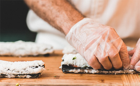 Person rolling sushi